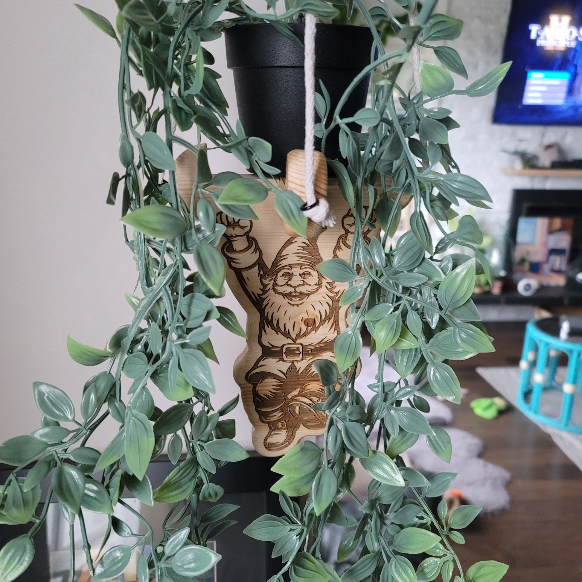 Gnome plant hanger design surrounded by green leaves