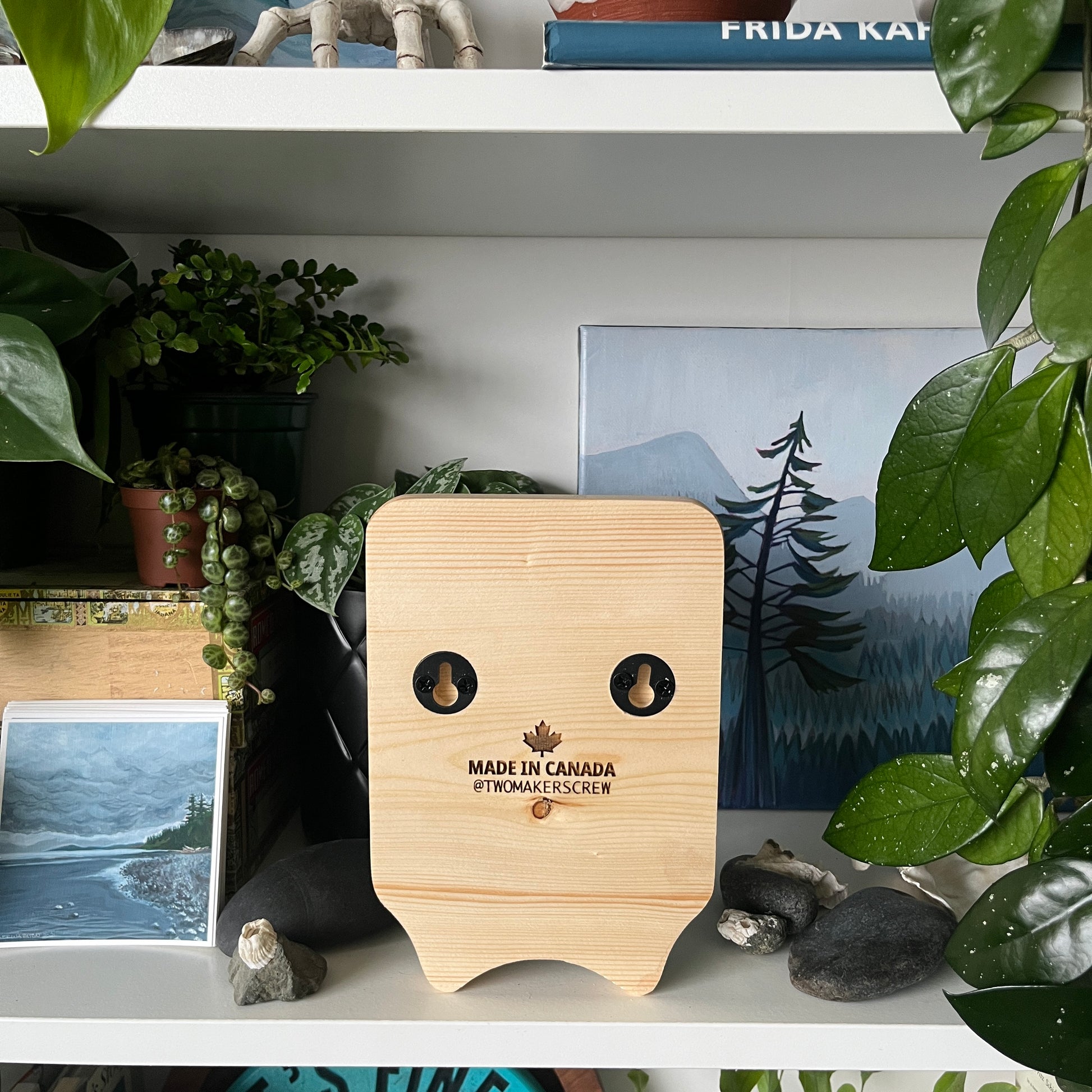 Wooden product with 'Made in Canada' label on a shelf with plants and decor