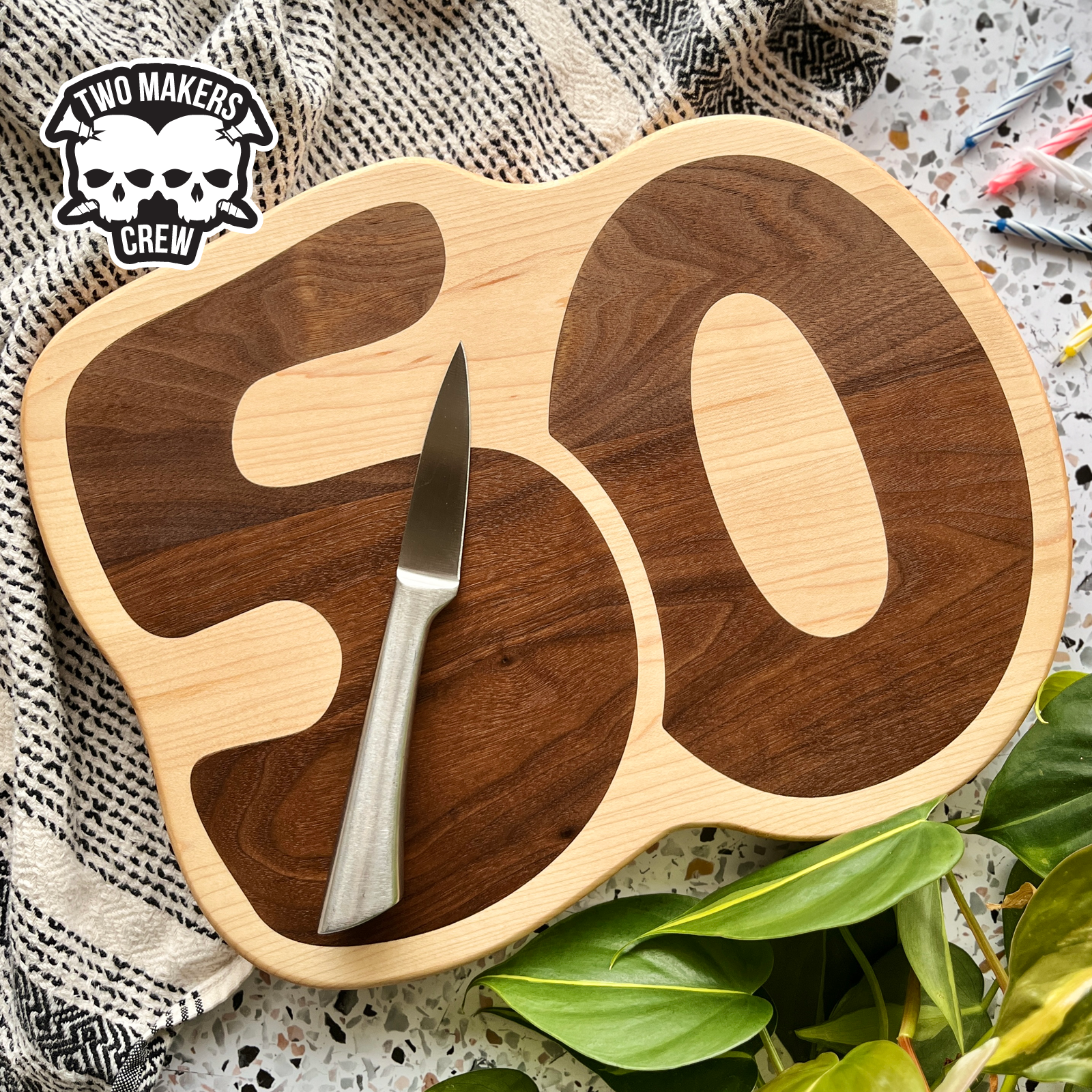 Maple cutting board with the number 50 inlayed with walnut