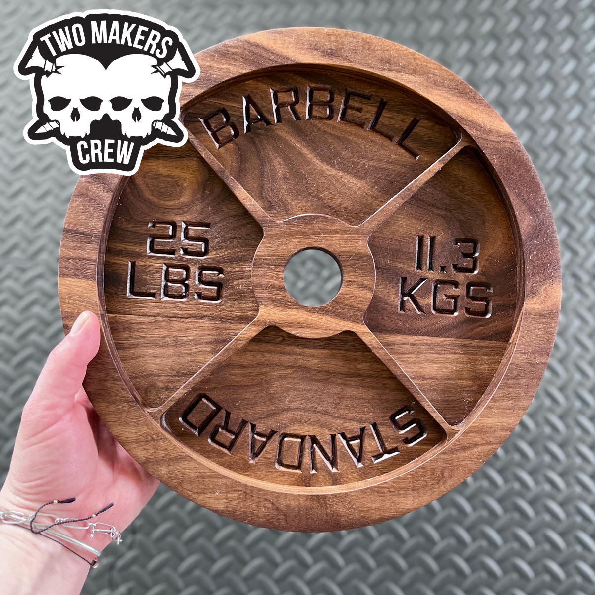 Dark walnut 25 lbs barbell weight plate tray made by Two Makers Crew. Perfect gift for athlete boyfriend